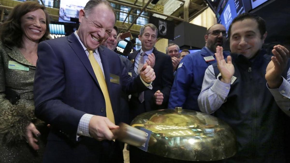Jeld-Wen’s President and CEO Mark Beck, left, rings a ceremonial bell on the floor of the New York Stock Exchange as his company’s IPO begins trading Friday, Jan. 27, 2017.