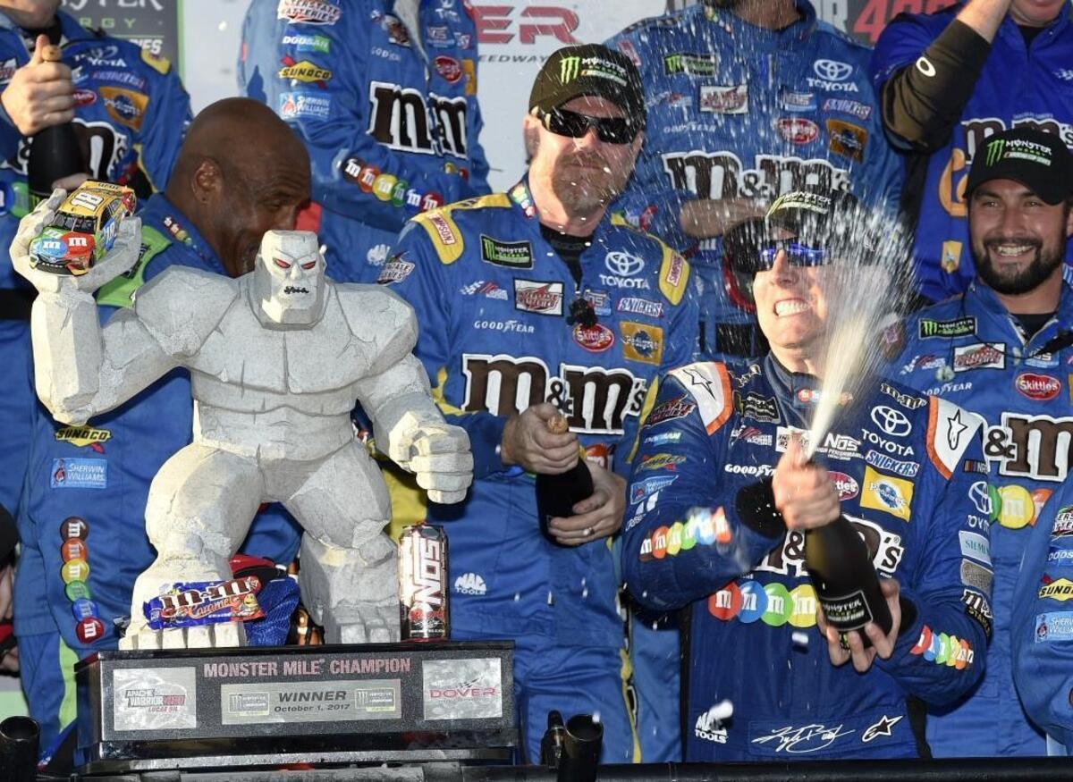 Kyle Busch, front right, celebrates in Victory Lane after winning a NASCAR Cup series auto race Oct. 1 at Dover International Speedway in Dover, Del. Corporate sponsors, including M&M’s maker Mars, play an especially important role in NASCAR.