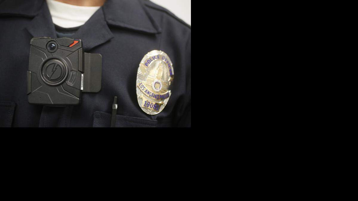 
A Los Angeles police officer wears an on-body camera during a demonstration for media in Los Angeles. In January, the Charlotte City Council voted unanimously to spend $7 million on a smaller body camera for its police force, vowing to equip each patrol officer with the lipstick-size device by October.
