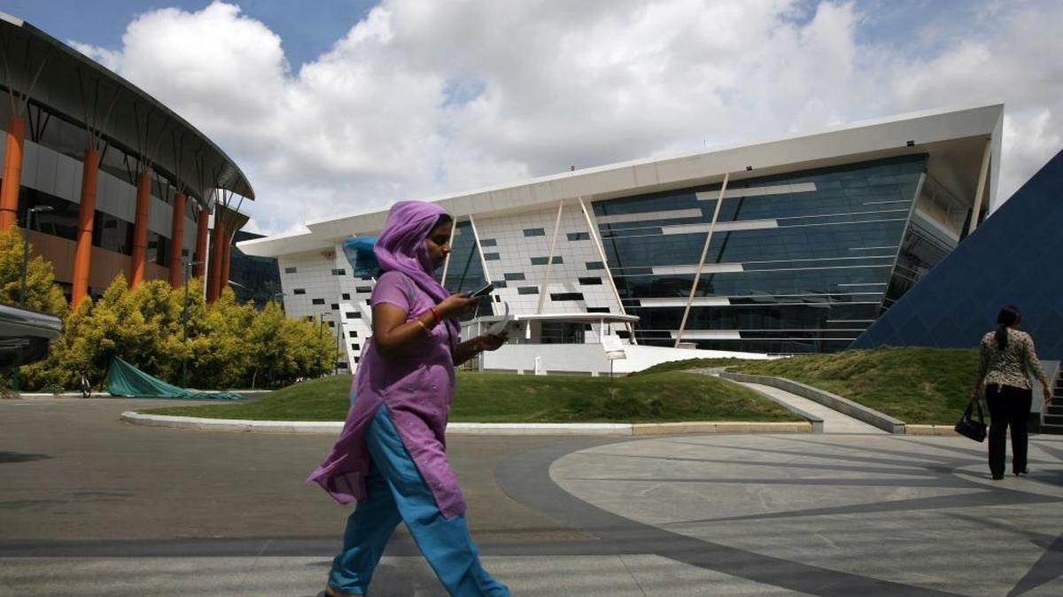 Employees walk around the campus of tech firm Infosys in Bangalore, India, in this 2008 file photo. The city is a hub for jobs off-shored by U.S. companies.