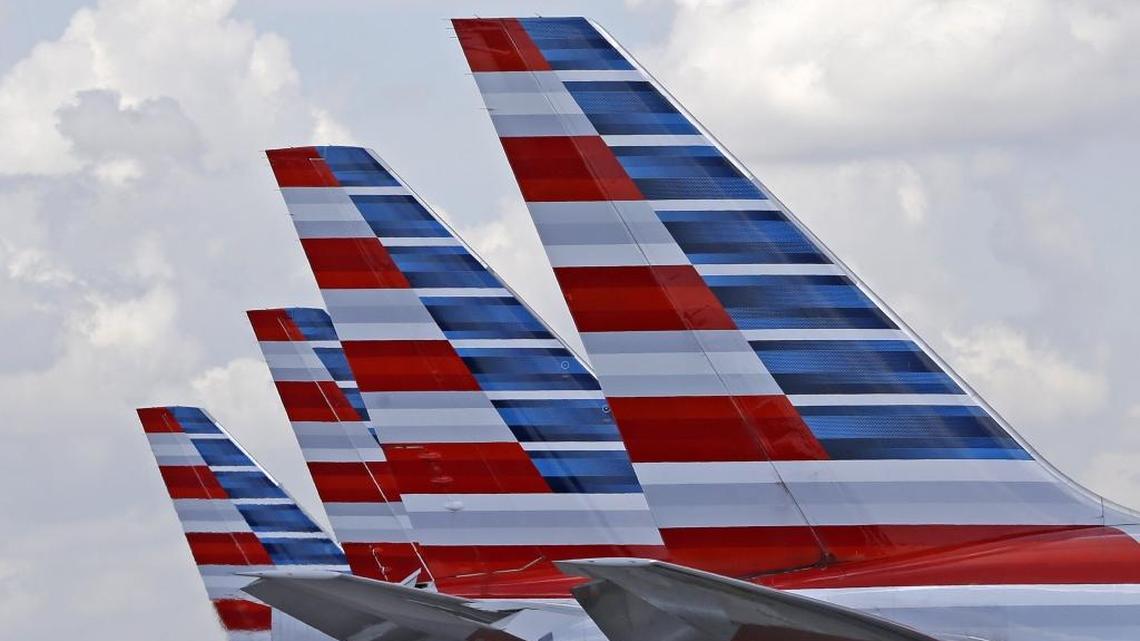This file photo shows the tails of four American Airlines passenger planes parked at Miami International Airport.