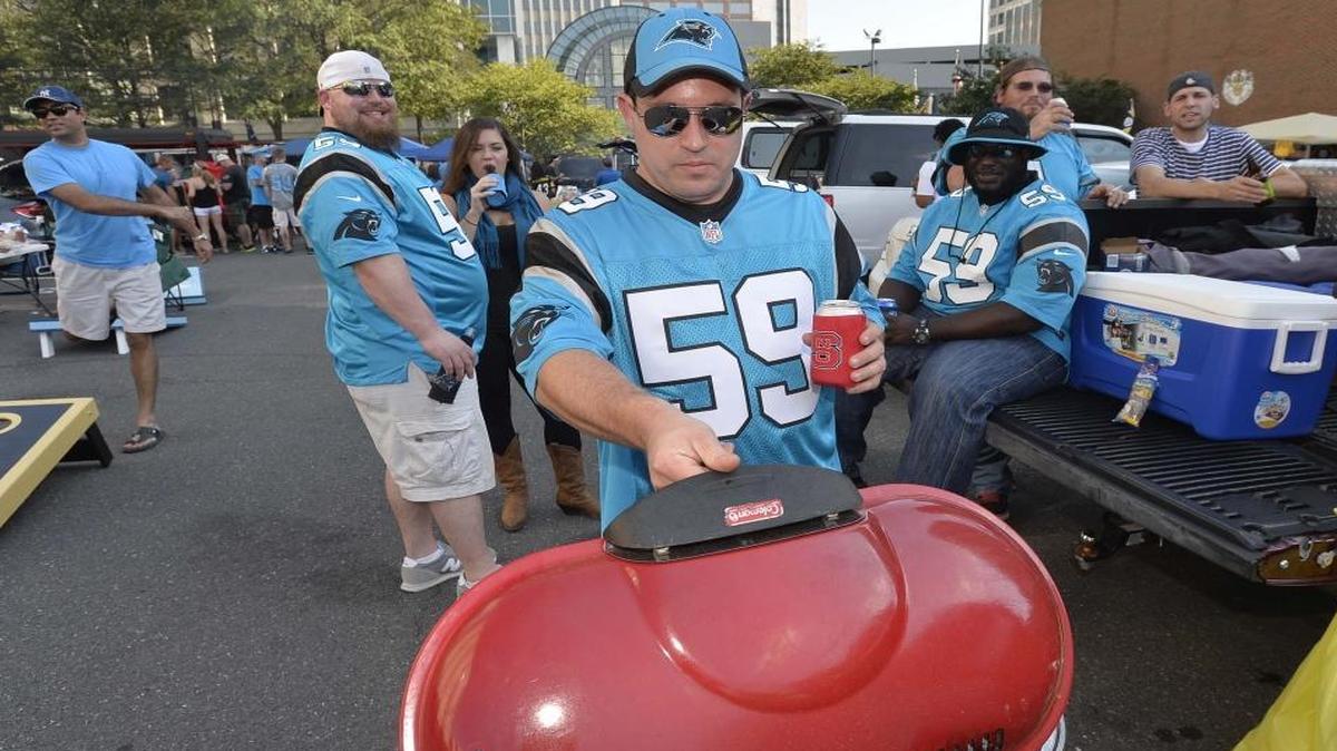 Carolina Panthers fan Miles Moore of Raleigh prepares to grill burgers while tailgating in uptown for the Sept. 20 game against Houston.