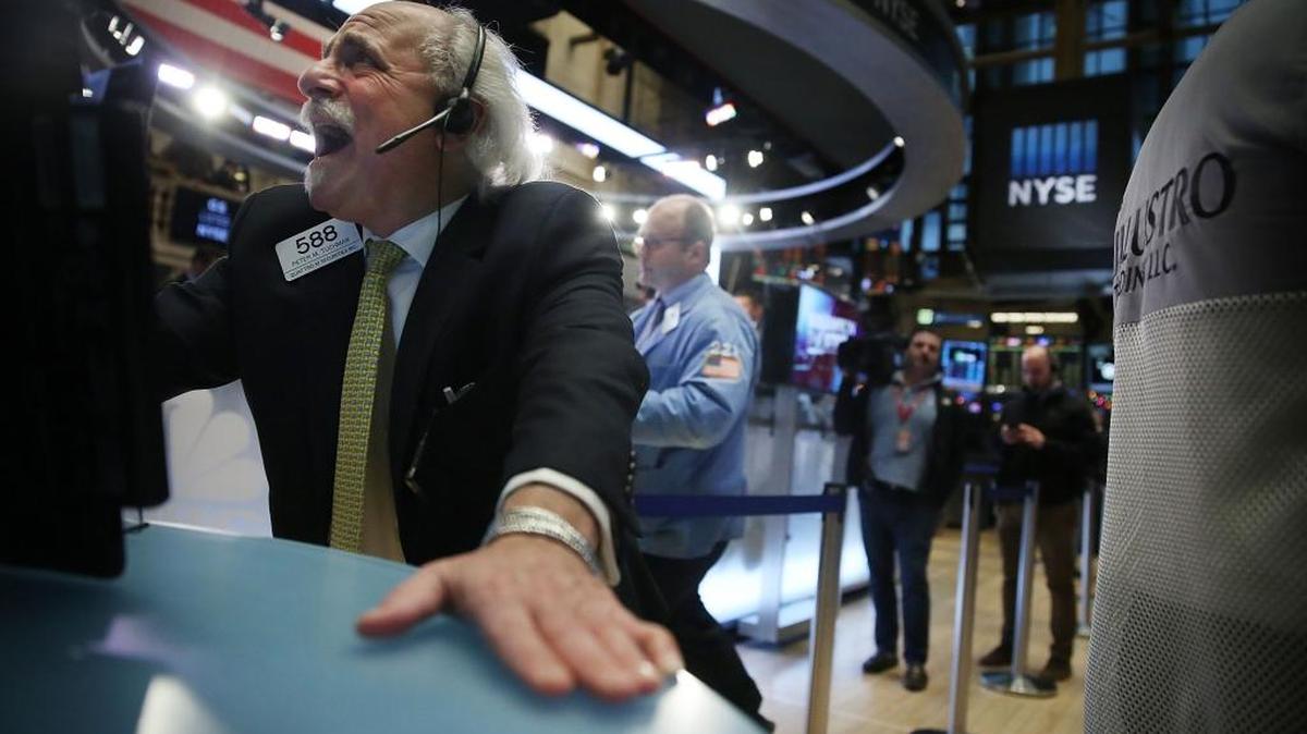 Traders work on the floor of the New York Stock Exchange on Thursday in New York City. Chinese stocks plunged on Thursday by more than 7 percent causing the Dow to drop over 200 points in morning trading.