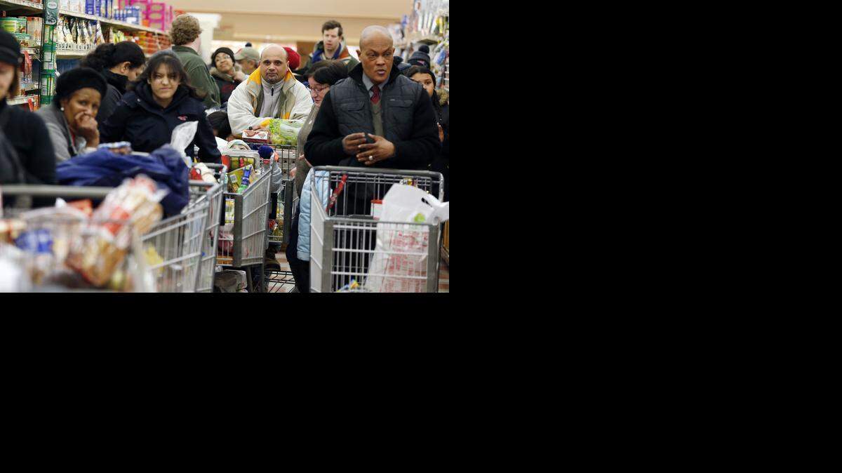 
Shoppers wait at the Market Basket in Chelsea, Mass., last weekend. Higher prices are weighing on shoppers’ perceptions of American retailers, a new report has found. 

