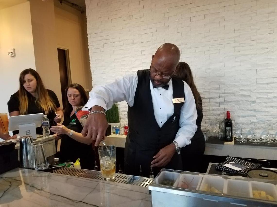 A bartender mixes a drink at the Sky Lounge bar, on the 50th floor of The Vue apartments.