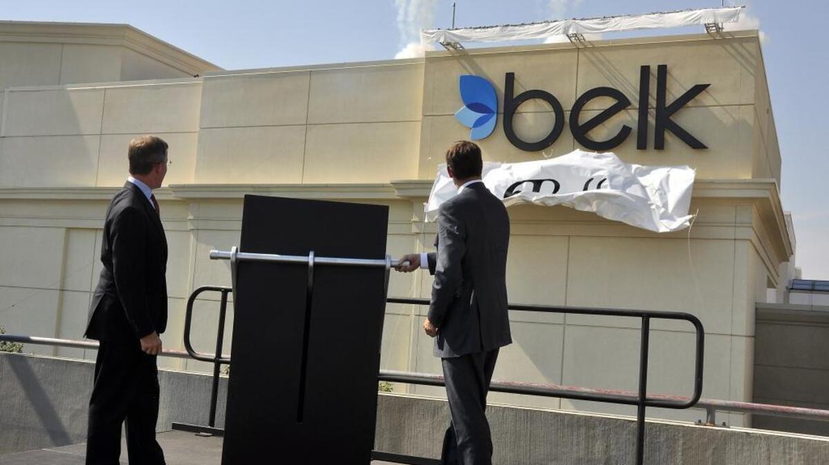 
Belk Chairman and CEO Tim Belk, left, and Belk President and Chief Operating Officer Johnny Belk unveil the new Belk logo and store signage at Belk at SouthPark Mall in fall 2010. The new logo and signage were part of a $70 million re-branding campaign. 
