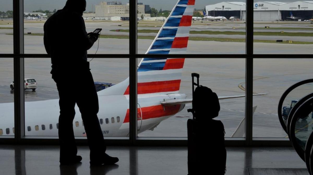
The silhouette of a traveler is seen at the American Airlines terminal of Miami International Airport on Sept. 23, 2014. 
