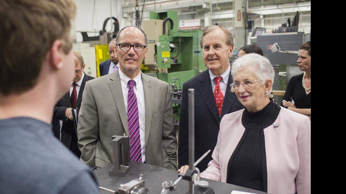 
U.S. Secretary of Labor Thomas Perez, left, and U.S. Representatives Robert Pittenger, center, and Virginia Foxx speak to an apprentice at Ameritech Die and Mold in in Mooresville, N.C. on Tuesday, June 30, 2015. 
