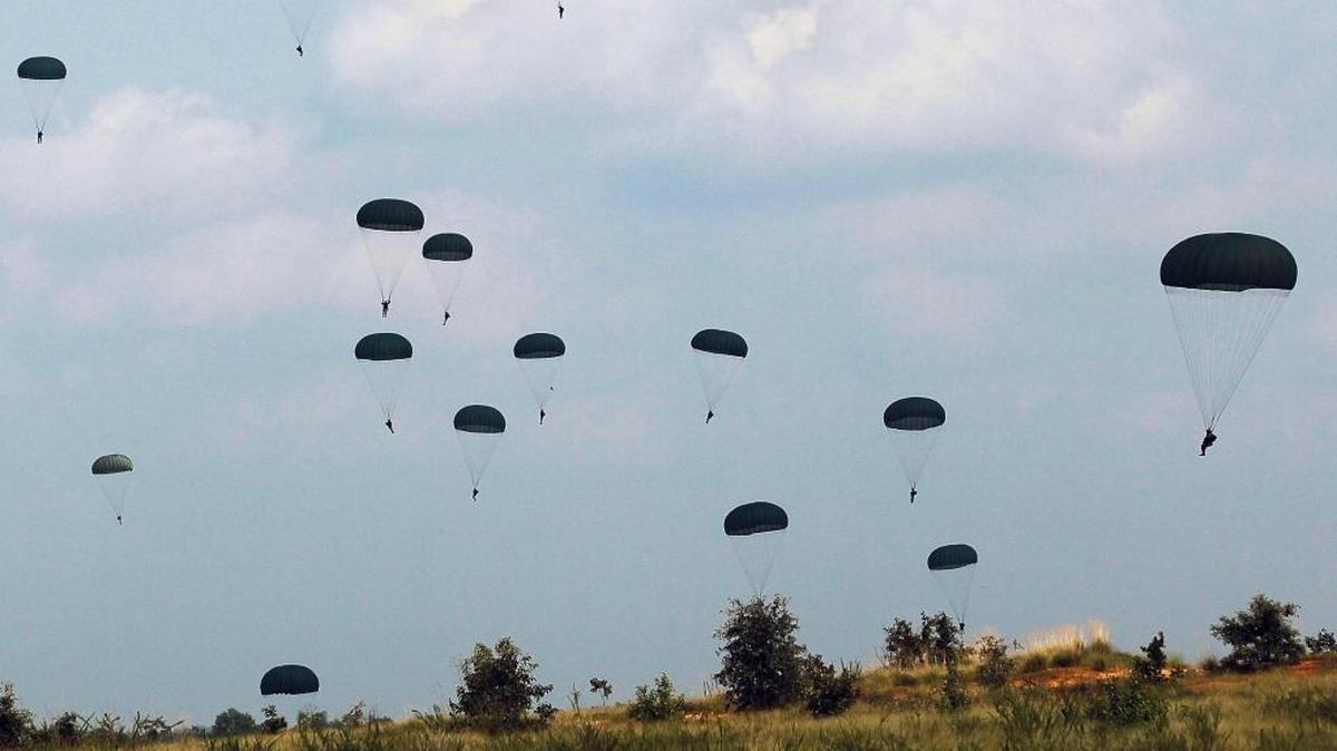 Paratroopers in the First Brigade of the US Army's 82nd Airborne Division parachute float to the ground during a training jump Aug. 6, 2010, at Camp Mackall, a training ground of Fort Bragg, N.C.