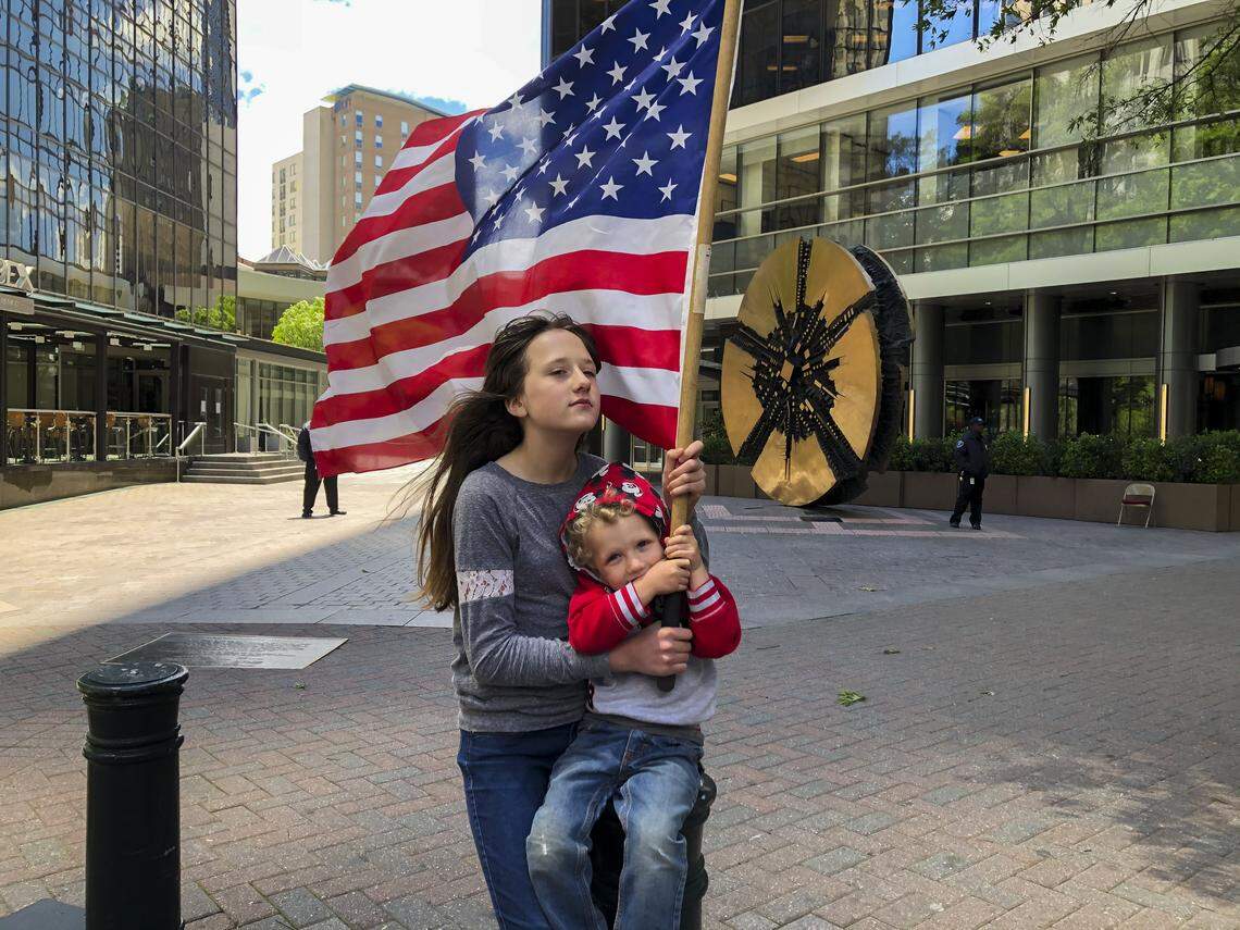 Reopen Meck members protest in uptown Charlotte coronavirus restrictions that have shut down businesses Friday, May 1, 2020.