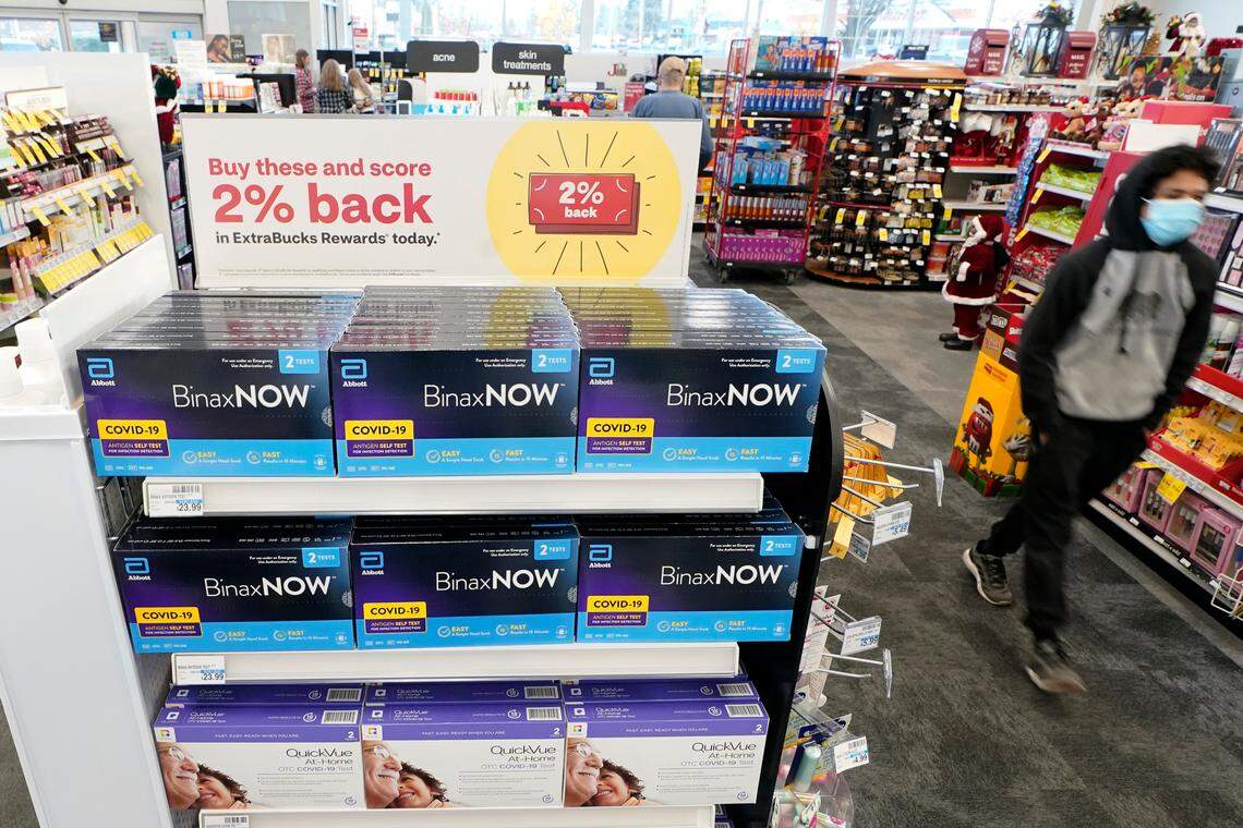Boxes of BinaxNOW and QuickVue home COVID-19 tests are shown for sale Monday, Nov. 15, 2021, at a CVS store in Lakewood, Washington.