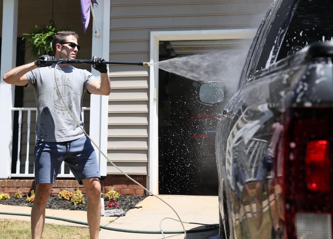 Connor Newsome washes his car Friday at his Fort Mill home.