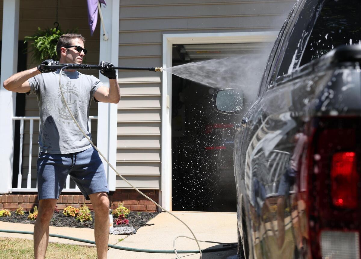 Connor Newsome washes his car Friday at his Fort Mill home.