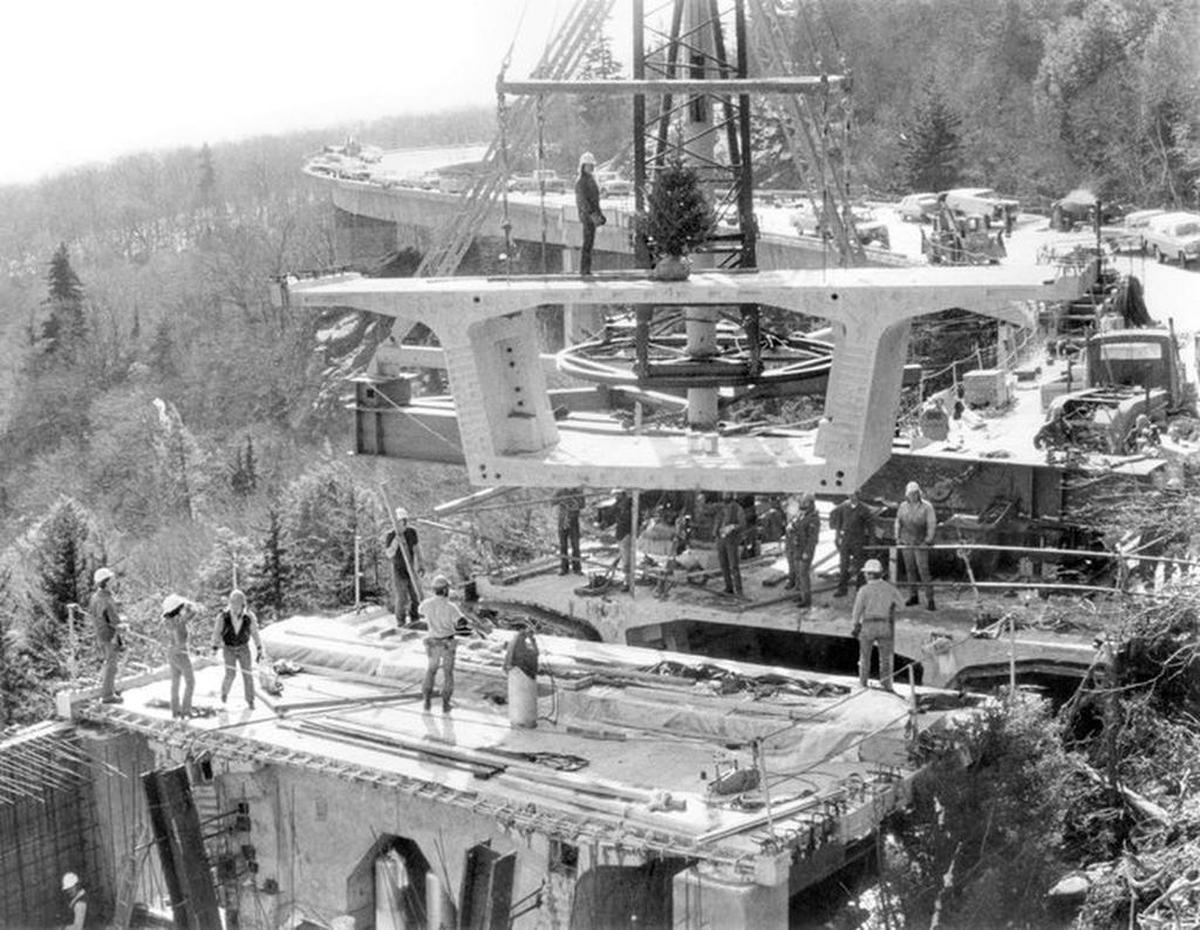 Workers assemble the Linn Cove Viaduct on the Blue Ridge Parkway. One of North Carolina’s most iconic road projects, the viaduct will be closed for resurfacing and bridge repairs from March 1 to May 24.
