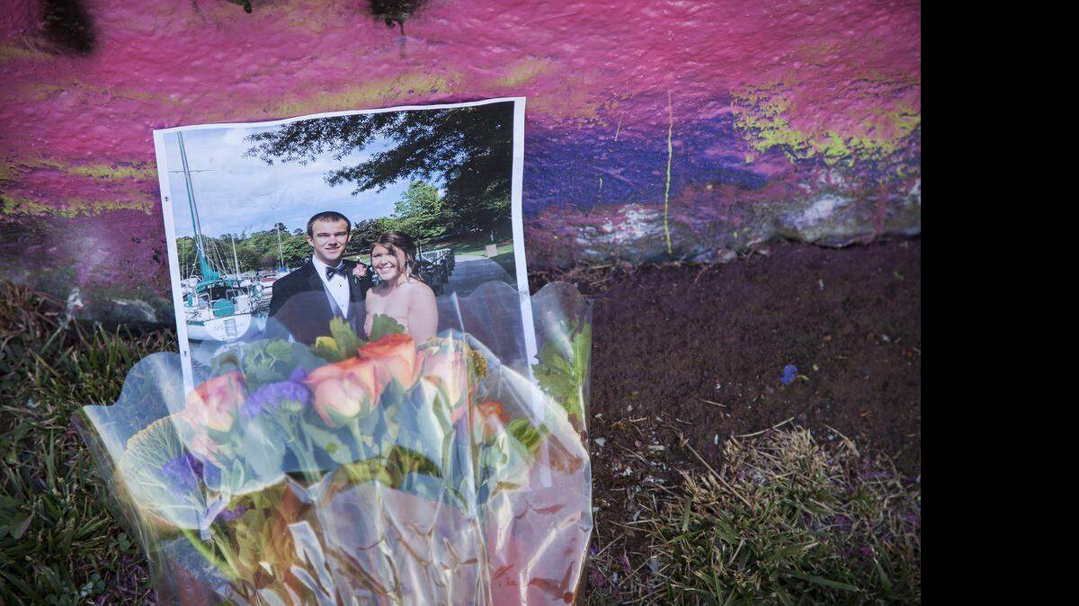 
Mourners brought flowers and photographs to remember Sheyenne Marshall at a public vigil at Cox Mill High School Sunday afternoon.
