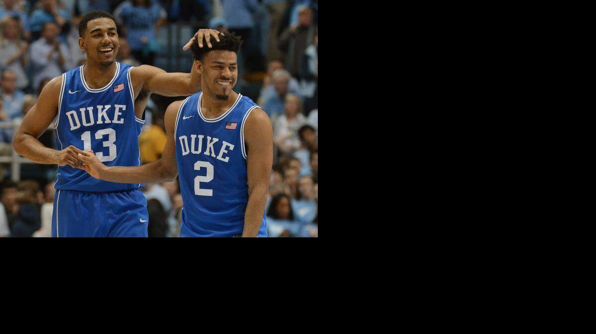 
Duke guard Matt Jones (13) celebrates with teammate Duke guard Quinn Cook (2) as Duke defeated UNC 84-77 at the Dean Smith Center in Chapel Hill, NC Saturday, March 7, 2015 in the final game of the regular season.
