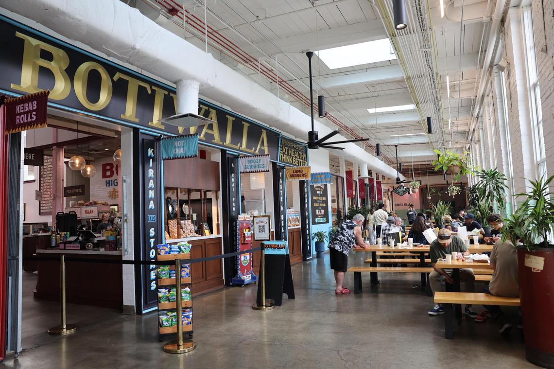 Customers at Optimist Hall in Charlotte eat near Botiwalla