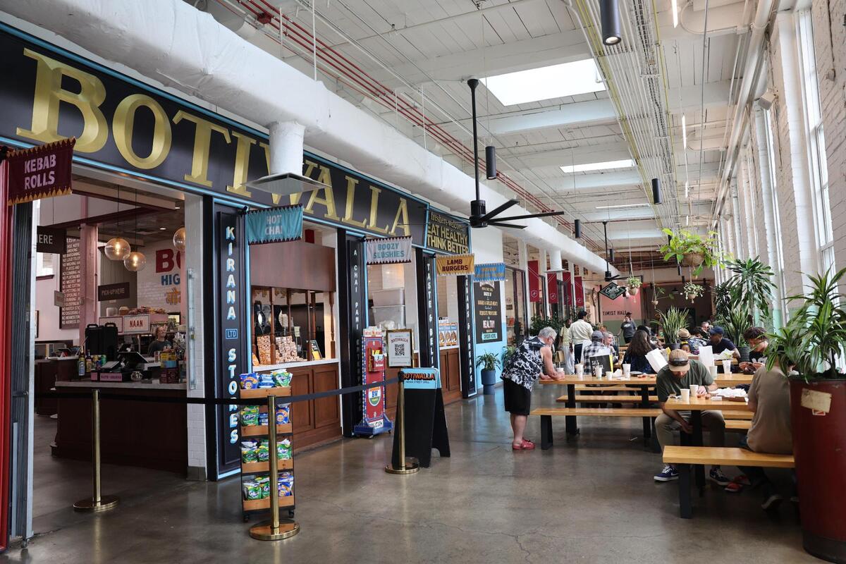 Customers at Optimist Hall in Charlotte eat near Botiwalla