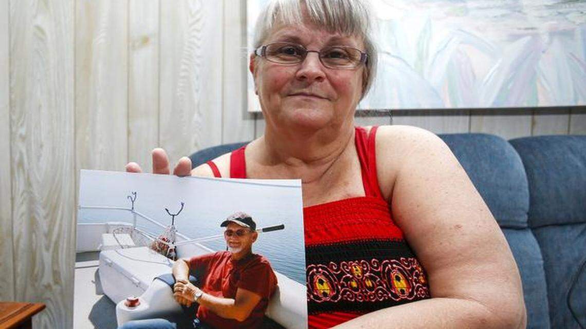 
Shirley Welch holds a photo of her late husband Mike Welch, at her Huntersville home Friday, April 10, 2015. Michael Doyle Welch was a roofer for 40 years. In November of 2012, the 64-year-old Huntersville resident lost his balance while working on a high-roofed house in Cornelius and was killed. But he was not listed among the 35 workers state officials included in their annual press release of workplace fatalities in 2012. (Nell Redmond photo)
