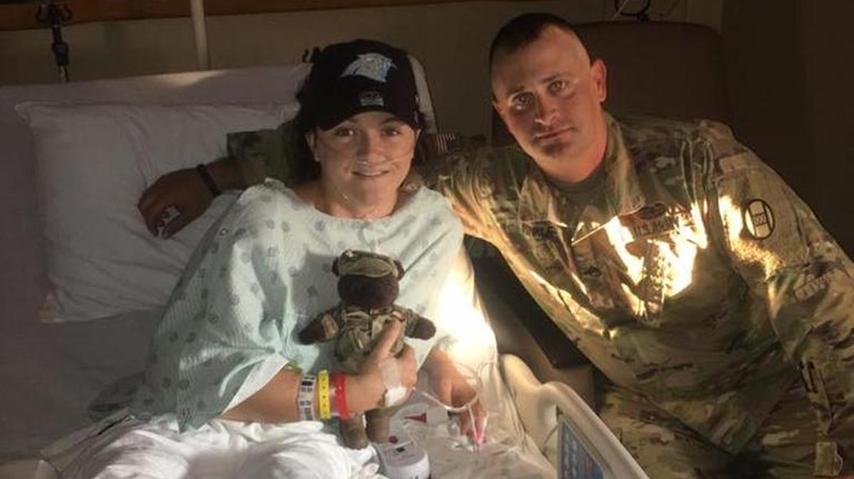 Sgt. Cory Hinkle , right, rescued Brandy Guin from a smoking car after a crash.