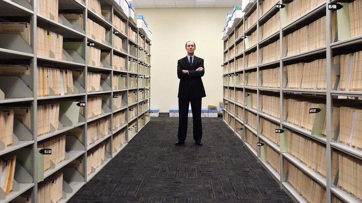 
In this 2015 photo Mecklenburg County Public Defender Kevin Tully stands among files in the public defender’s office. 