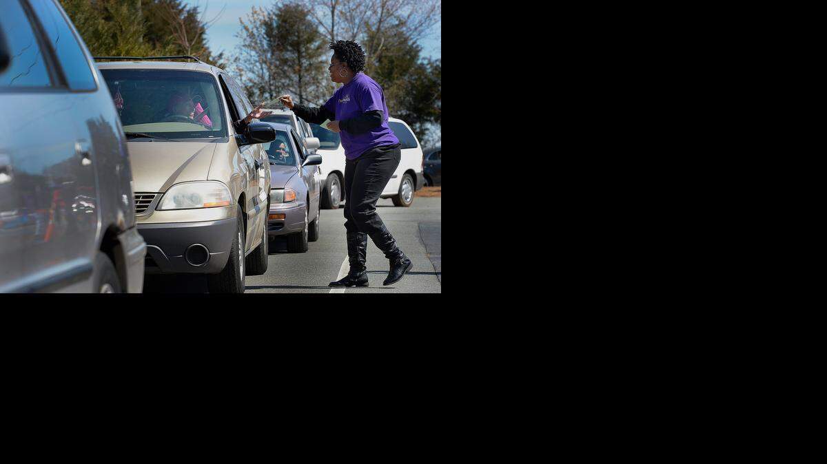 
Karen Richardson, a member of New Beginnings Church, helps hand out gas cards in 2013.
