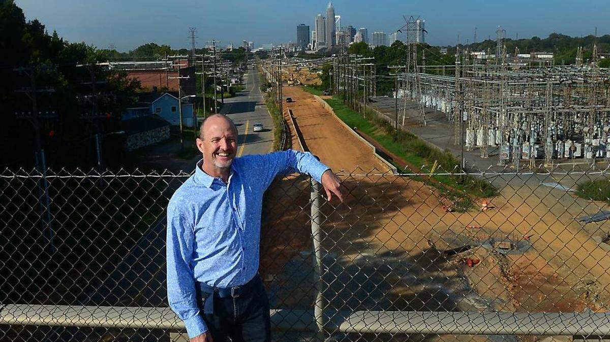 
Danny Rogers, Blue Line Extension project director, surveys light rail construction progress from atop the Matheson Avenue bridge in NoDa Friday, August 28, 2014.
