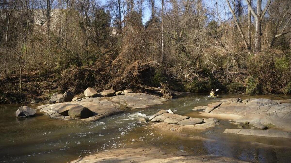 
A paddler runs a small rapid on a naturally-flowing section of Little Sugar Creek in south Charlotte. Mecklenburg County officials say parts of the creek tested positive for high levels of chemical contaminants. 
