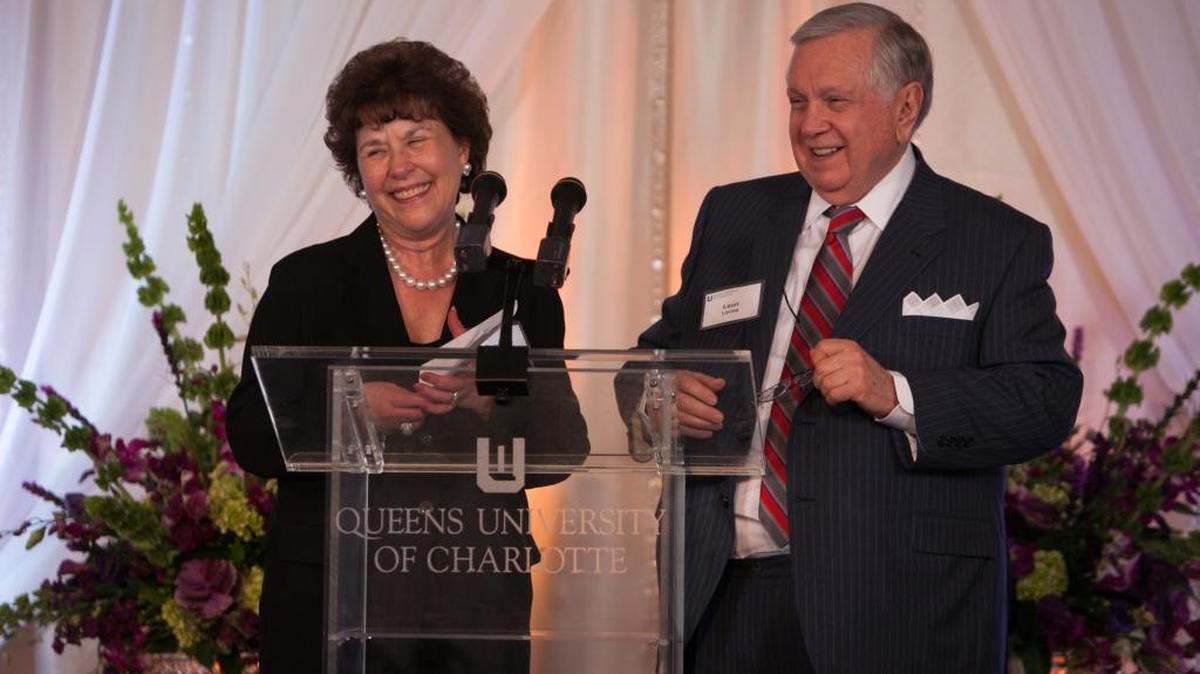 Leon and Sandra Levine stand at a podium at the 24th Annual Royal Society Dinner at Queens University.