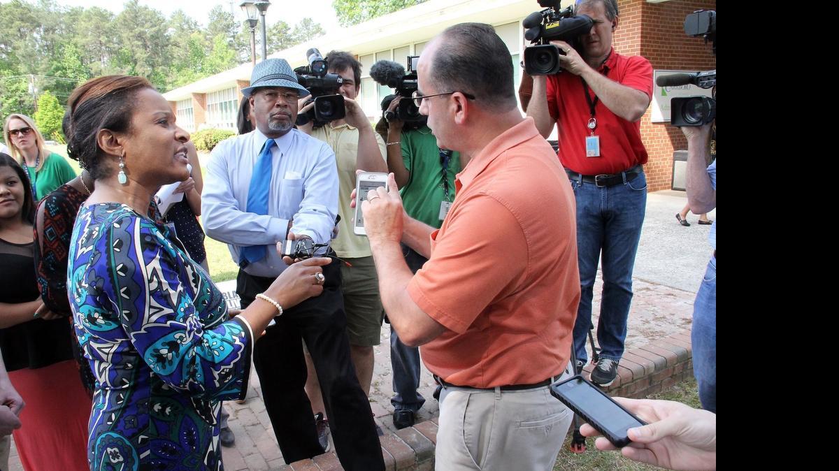 
Michelle Laws, left, executive director of the state NAACP, speaks with Ronald Creatore, father of one of the two East Chapel Hill High School students in the Instagram photo. Some are demanding a stronger response from the school system. 
