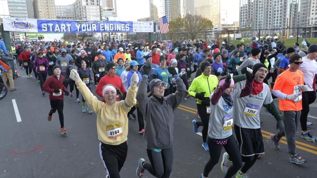 Runners take off at the start of the 2014 Thunder Road Marathon and Half-Marathon at the intersection of Fourth Street and North Graham Street in uptown.
