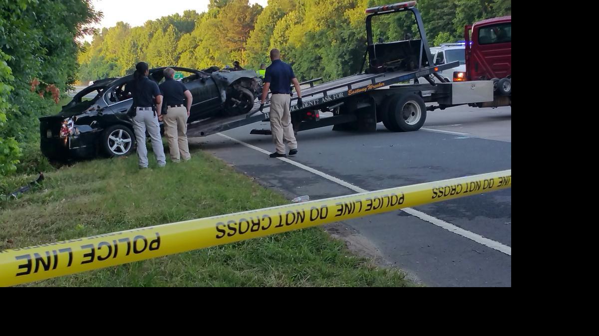 
Authorities prepare to tow a car involved in a fatal crash early Friday on Billy Graham Parkway.

