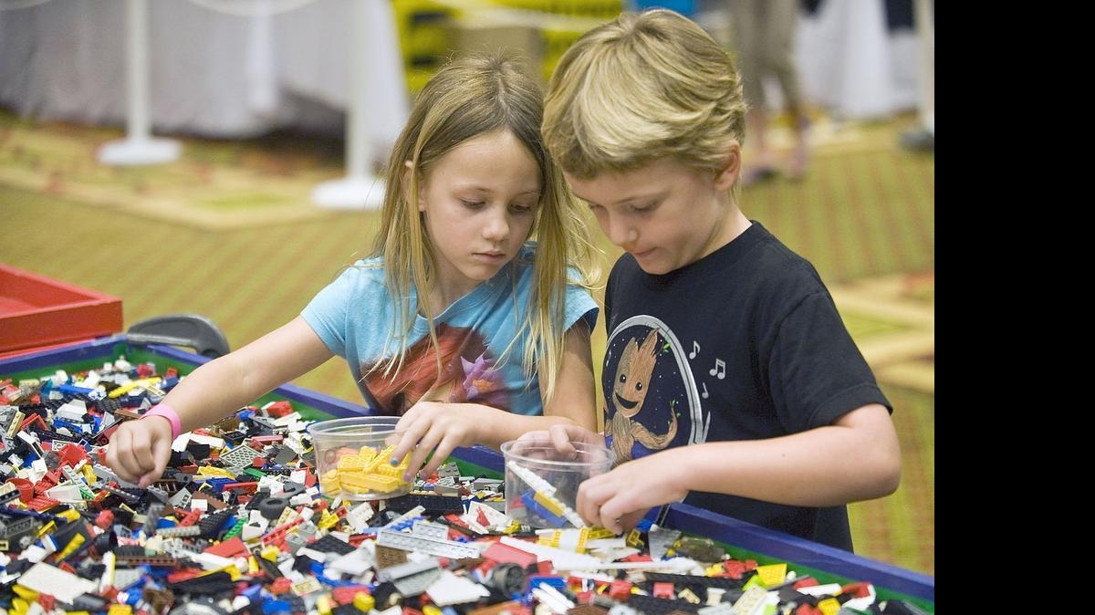 
 Avery Scrivener, 4, and brother Quintin pick out LEGOs at a festival in Concord this May.
