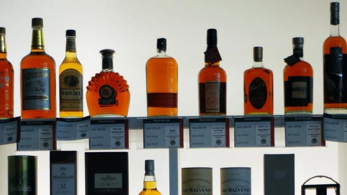 Bottles line the shelves of a liquor store.