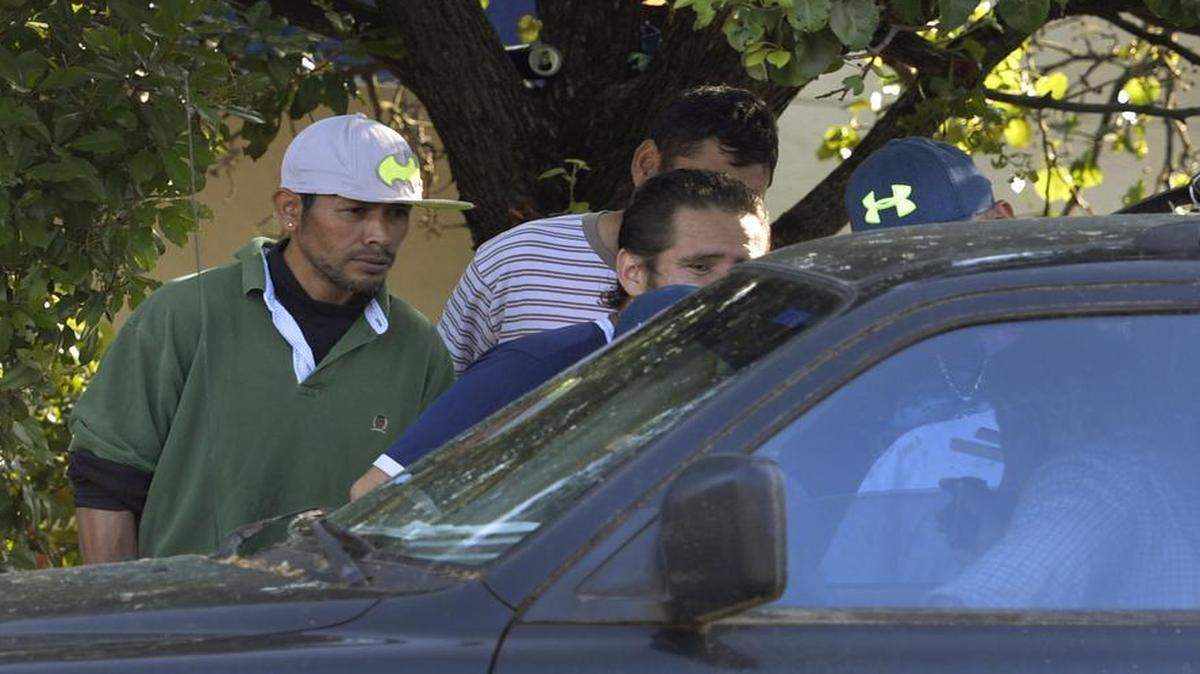 
Day laborers gather on North Wendover Road, negotiating pay with people who stop by looking for workers.

