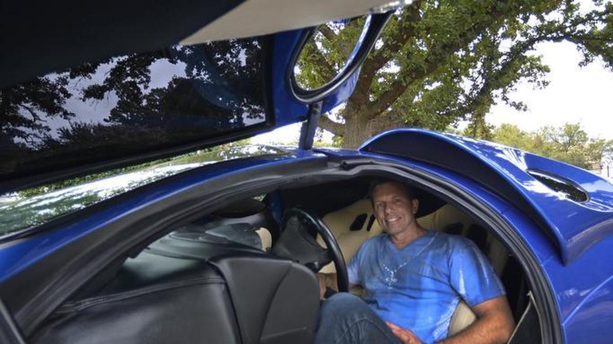 
Mike Vetter with his futuristic concept ETV that will be on display during the Charlotte AutoFair,September 24-27 at Charlotte Motor Speedway. After the birth of his daughter, Vetter began brainstorming a futuristic car that could comfortably carry a small family in a body that no one had ever seen before. 
