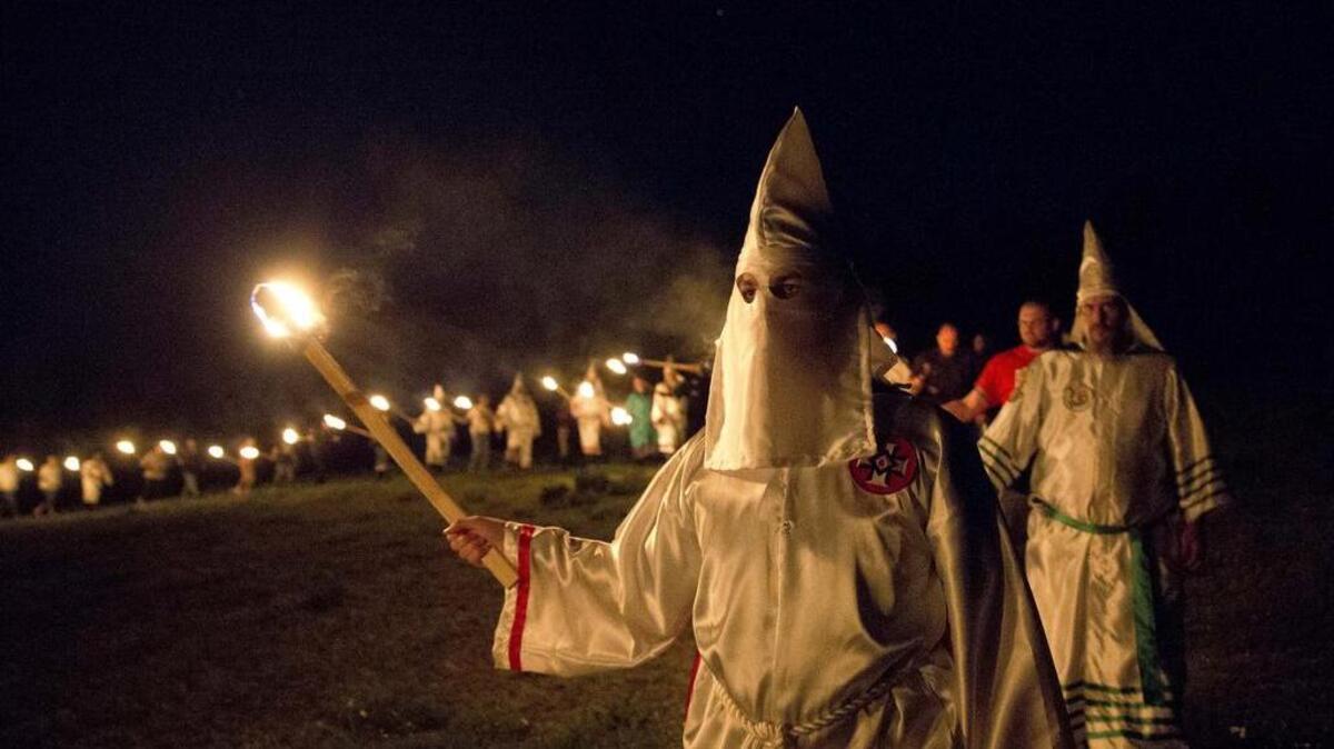 Ku Klux Klan members participate in cross burnings on April 23 after a “white pride” rally in rural Paulding County near Cedar Town, Ga.