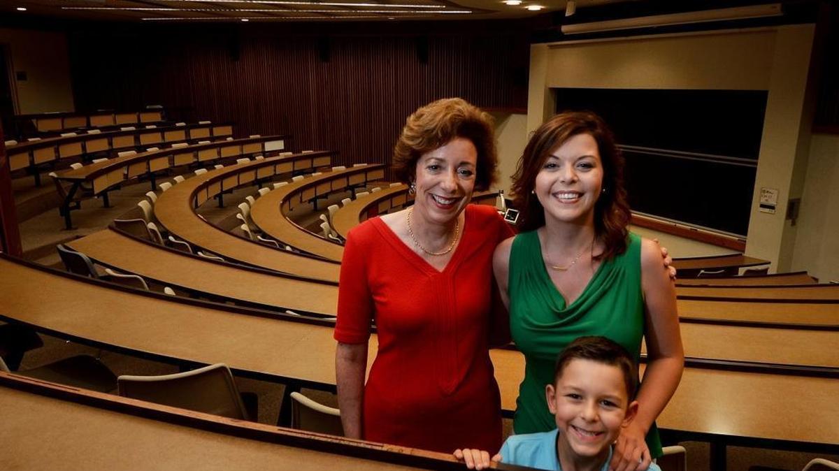 Susan Andersen, left, founder of a Charlotte scholarship for mothers attending college, with Amanda Ruiz and her son Jayden, 8, at the Belk College of Business at UNC Charlotte. Ruiz, who is working on a degree in finance at UNCC, is a recipient of the ANSWER scholarship.