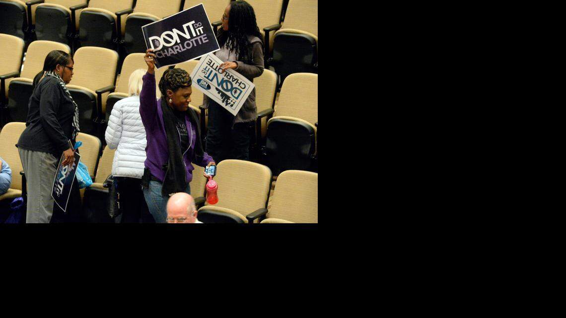 
A supporter of Don't Do It Charlotte waves a poster in the air after the Charlotte City Council voted down the amended nondiscrimination ordinance during a meeting of the Charlotte City Council at the Charlotte Mecklenburg Government Center on Monday. 
