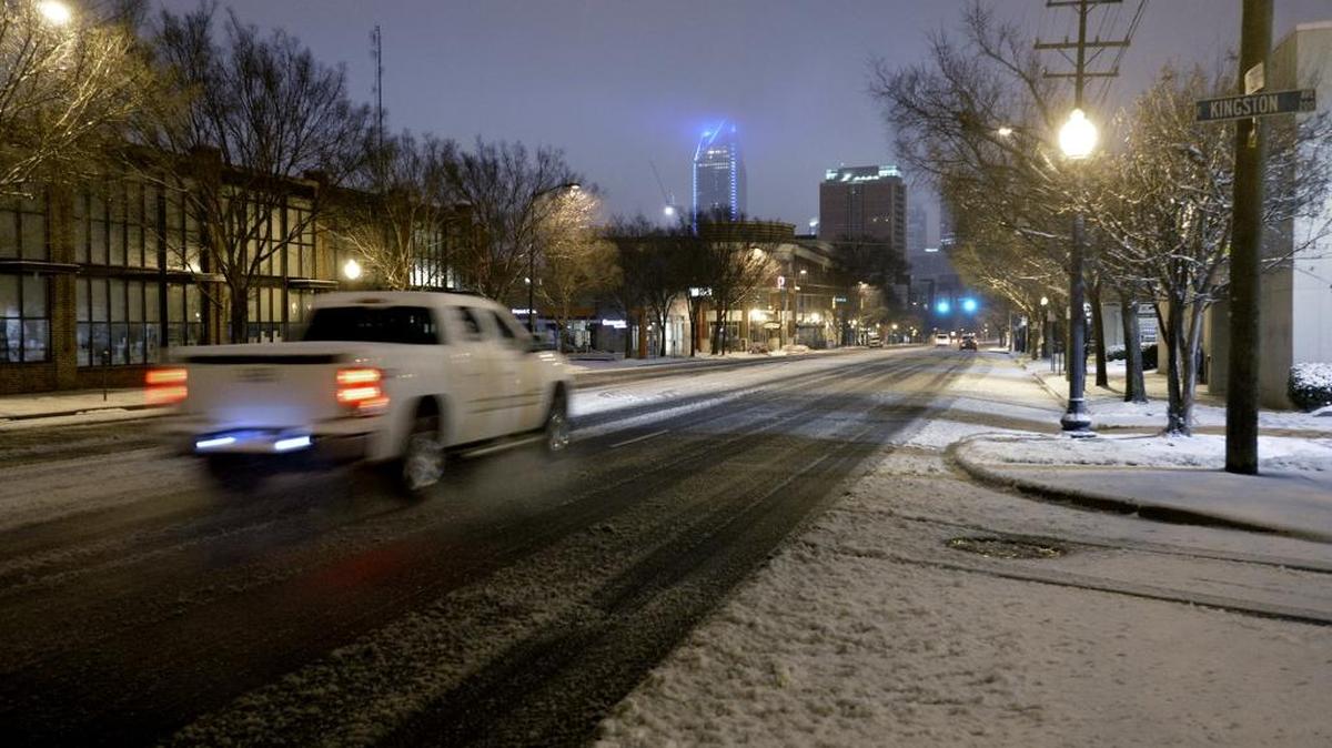 Commuters brave ice and snow as they head along South Boulevard toward uptown Charlotte early Friday morning, January 22, 2016.