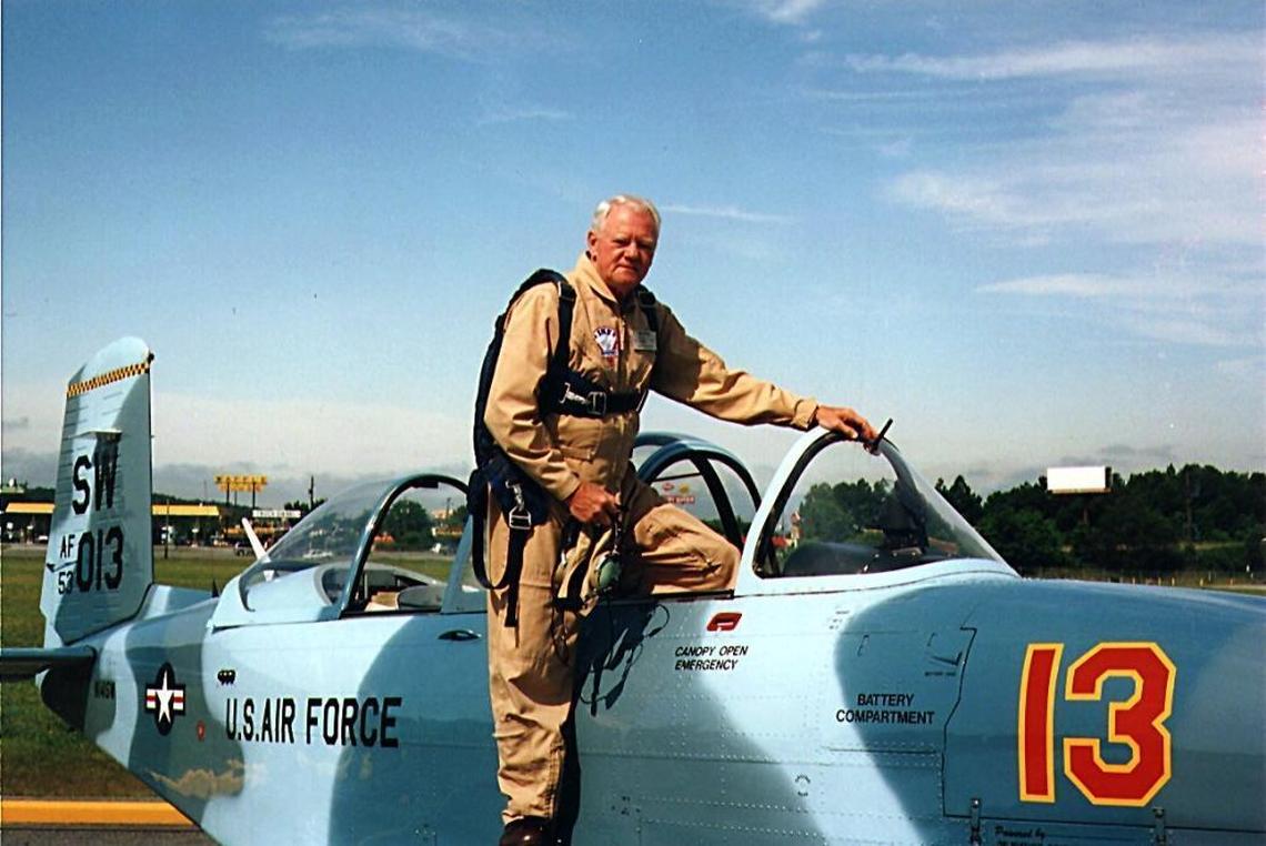 Robert D. Raiford and the restored U.S. Air Force T-34 flight trainer he flew in a dogfight with his son Ray.