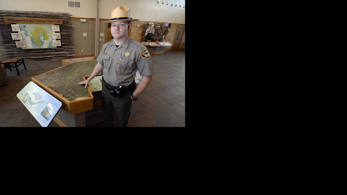 
Jarid Church, the acting park superintendent for Lake Norman State Park, with an information table inside the lobby of the new Lake Norman State Park Visitor Center on Monday. Officials will dedicate the $4.3 million, 11,000-square-foot visitor center on April 23. 
