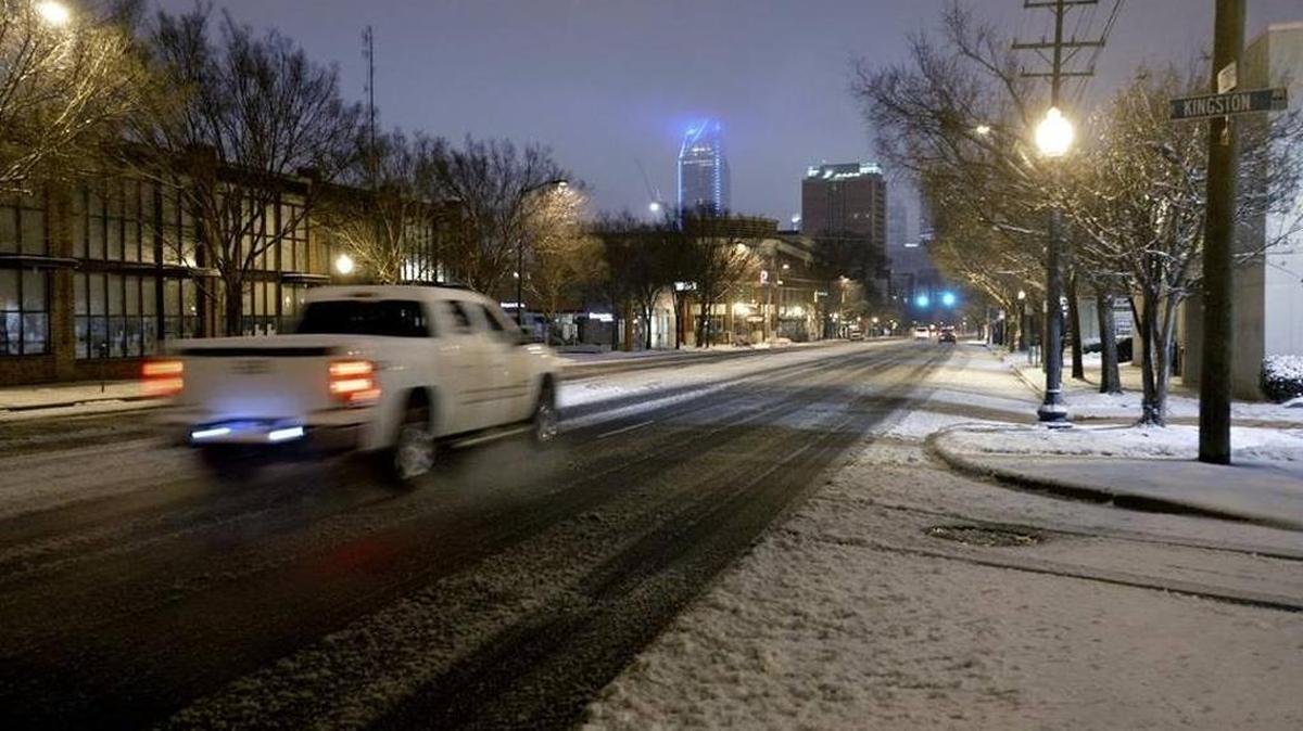 Commuters brave ice and snow as they head along South Boulevard toward uptown Charlotte early Friday morning, January 22, 2016.