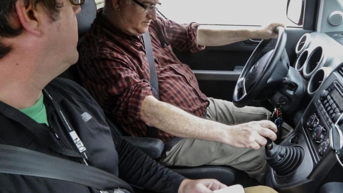 Columnist Josh Shaffer, left, teaches News & Observer senior editor Dan Barkin, 62, how to drive a vehicle with a manual transmission.