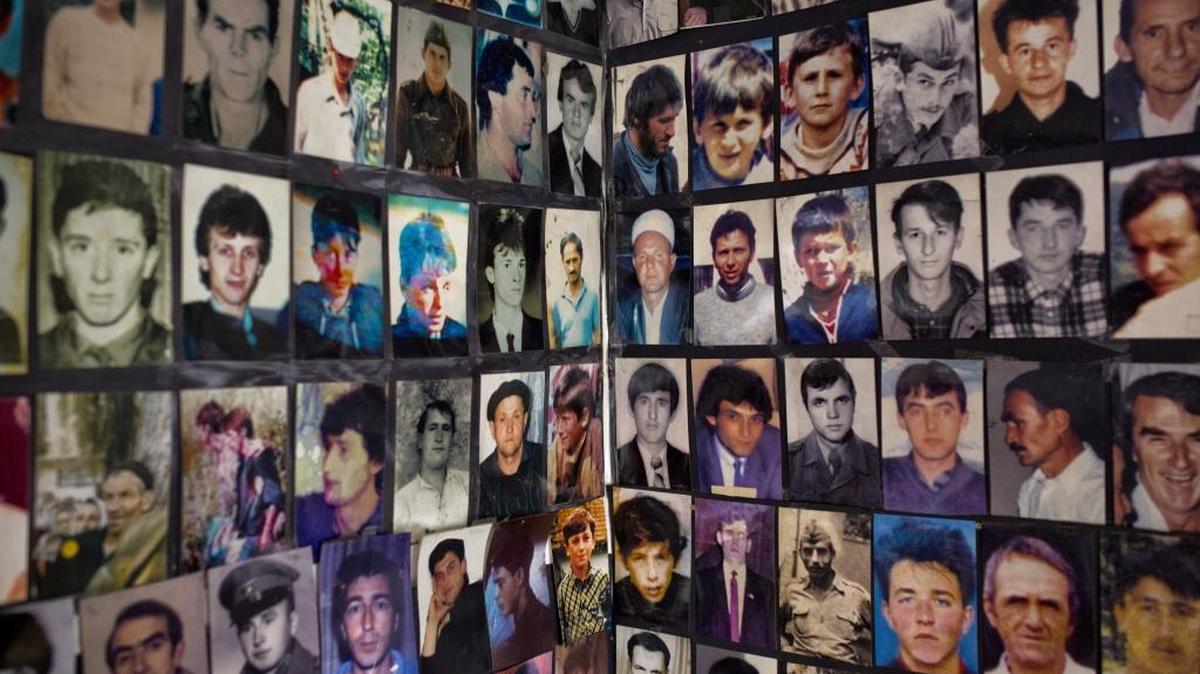 In this Nov. 11, 2017, picture, photos of the 1995 Srebrenica massacre dead and missing, are placed on a wall at the Srebrenica Women Union in Tuzla, Bosnia. On Monday, a Charlotte truck driver, Milan Trisic, pleaded guilty to lying about his role in the slaughter in order to be allowed into the United States. (AP Photo/Amel Emric)