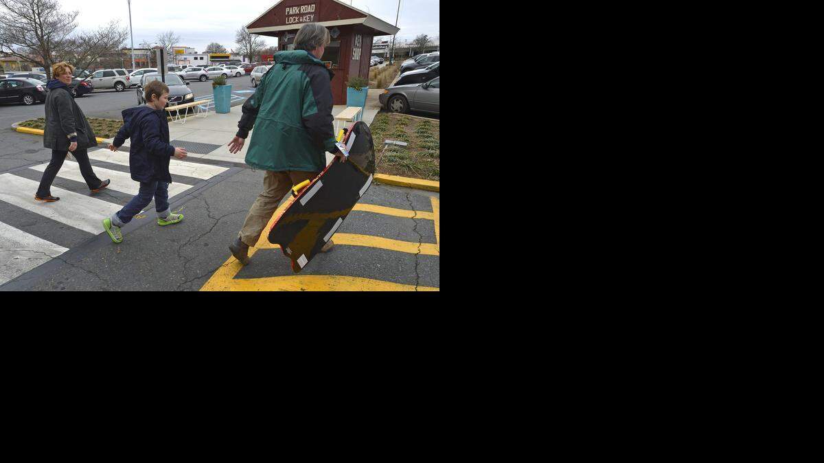 
Phillip Ingold, wife Billie and 8-year-old son Alexander head home with a new sled just purchased at Blackhawk Hardware at the Park Road Shopping Center Monday morning .
