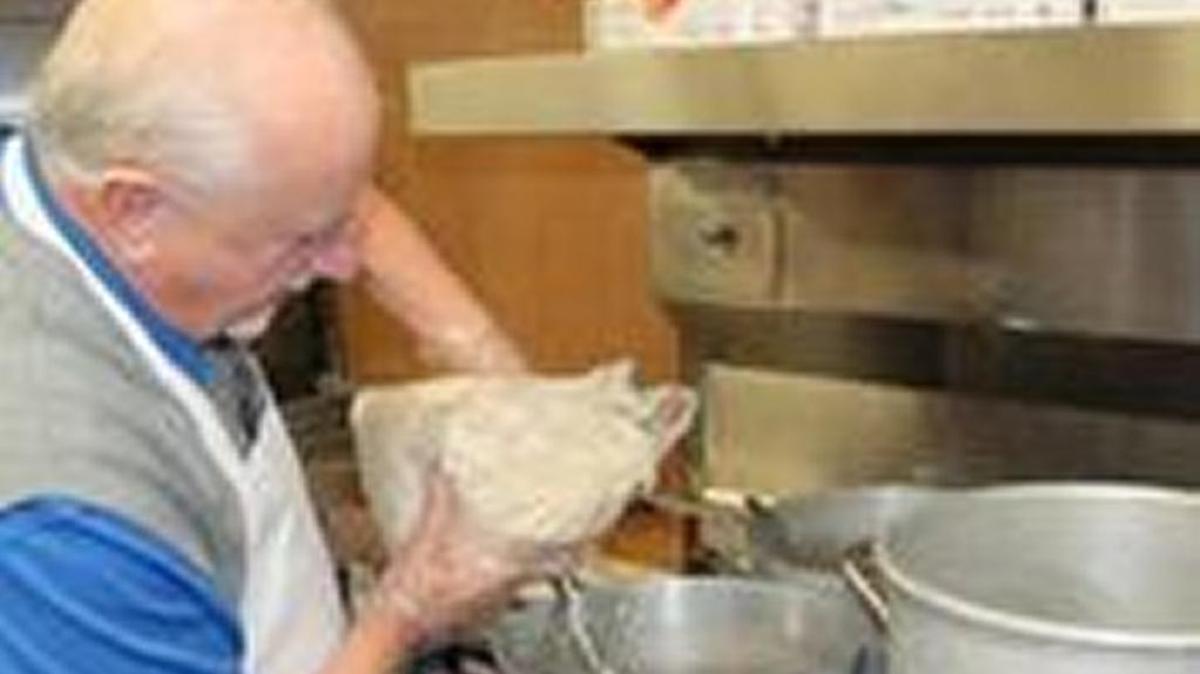 Bob Bishop, a deacon at Myers Park Baptist Church, prepares oatmeal at an area homeless shelter. Bishop is organizing a drive to collect oatmeal and other food for the region’s homeless.