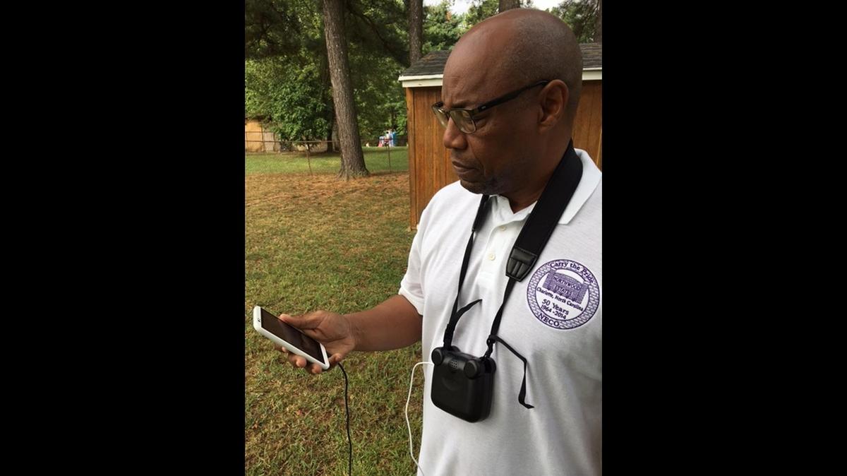 Photo from 2016 of Northwood Estates resident Ron Ross with a portable air-quality monitor.