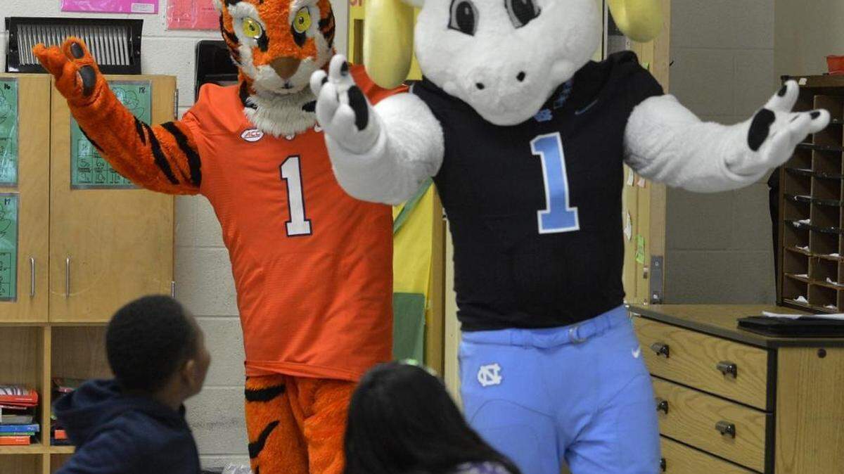 Clemson mascot "The Tiger" and UNC mascot "Rameses" surprise third graders at Sedgefield Elementery School on Friday.