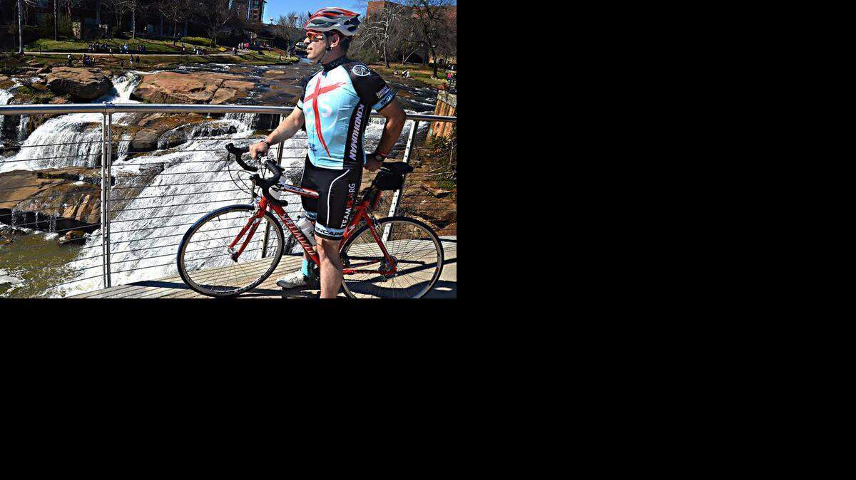 
Cyclist John Detwiler Jr. takes in the Reedy River waterfalls in Falls Park on the Reedy in downtown Greenville, S.C. The Swamp Rabbit Trail, which runs on the far bank, extends nearly 20 miles from Greenville north through Furman University to Travelers Rest.
